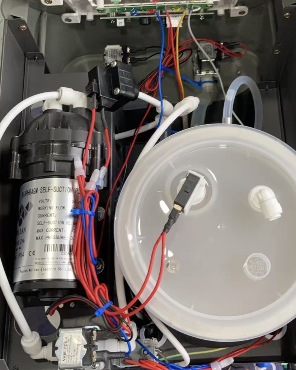 Installed water dispenser pump and internal tubing